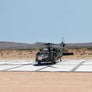 Photo of a military helicopter that has landed on a Mobi-Heli Portable helipad that has been deployed in the outback.