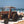 A Mobi-Boat Ramp has been rolled out on sand on a beach. An old red tractor has pulled a dingy out of the water and is pulling it along the boat ramp