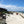 Photo of Surf Club building and beach view. Surf-lifesaving flags are set up on the beach with Surf-Lifesavers in the distance. Mobi-Fence is in the foreground running horizontally with the coastline and the ocean to help stop sand movement. 