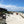 Photo of Surf Club building and beach view. Surf-lifesaving flags are set up on the beach with Surf-Lifesavers in the distance. Mobi-Fence is in the foreground running horizontally with the coastline and the ocean to help stop sand movement. 