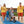 Mob-Path being used on the beach by a child in a three wheeled wheelchair with two surf lifesavers and two other children