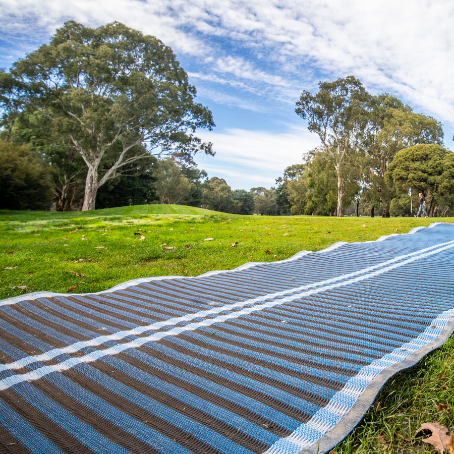 Close up angle shot of blue mobi-road rolled out onto grass.