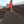 Photograph of a workman rolling out a Mobi- Path / Roadway along reinforced iron mesh at a construction site. Walking away from photographer. 